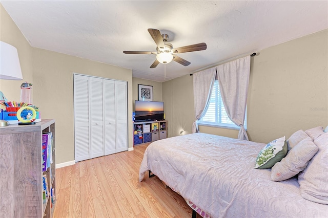 bedroom featuring ceiling fan, a closet, and wood-type flooring