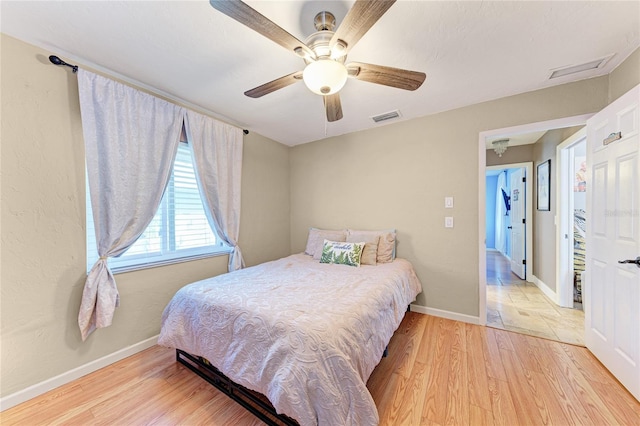 bedroom with light wood-type flooring and ceiling fan