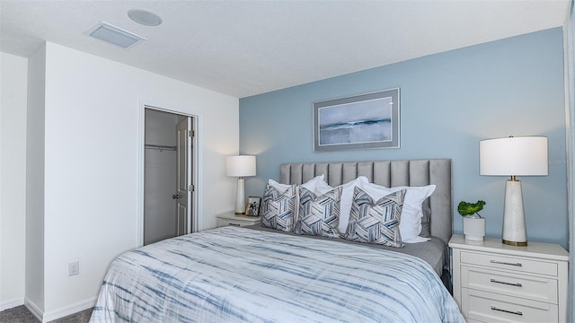 bedroom featuring a walk in closet and a closet