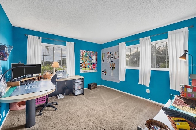 home office featuring carpet flooring and a textured ceiling