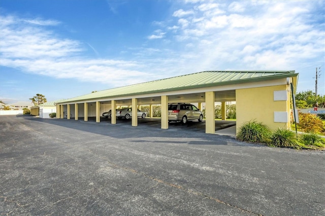 view of vehicle parking with a carport