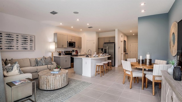 living room with sink and light tile patterned floors