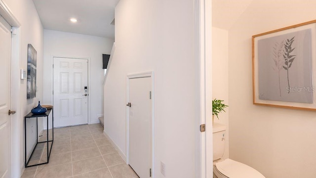 corridor featuring light tile patterned floors