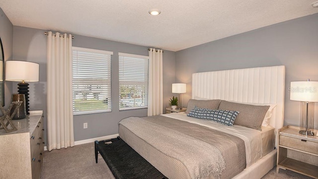 carpeted bedroom with a textured ceiling