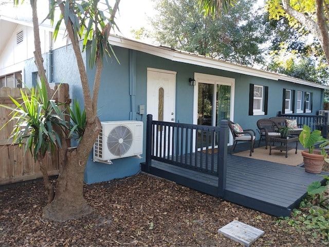 wooden deck featuring ac unit and outdoor lounge area