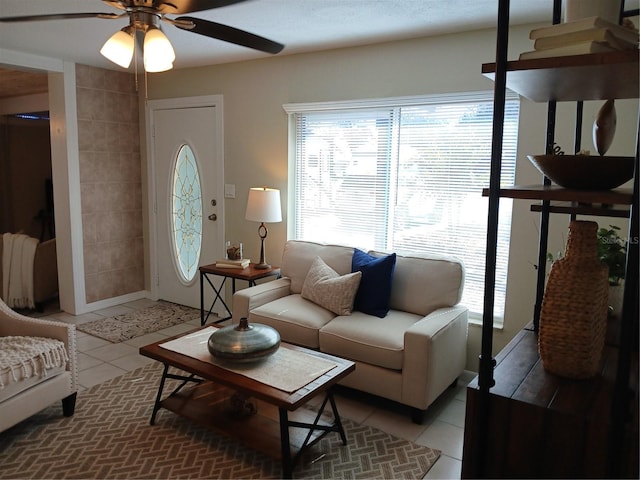 living room with ceiling fan and light tile patterned floors