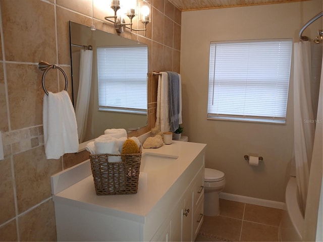 bathroom with toilet, vanity, tile patterned flooring, and curtained shower