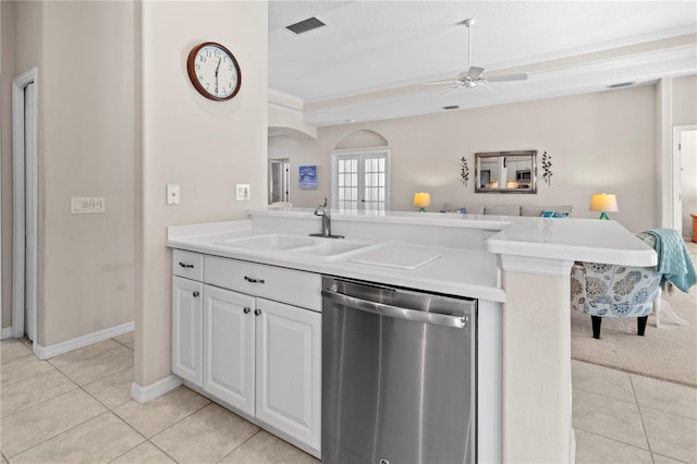 kitchen featuring white cabinets, light tile patterned floors, stainless steel dishwasher, and sink