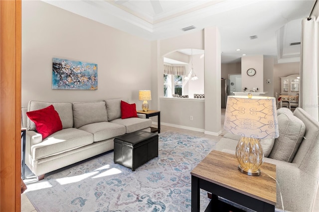 living room featuring crown molding and a tray ceiling