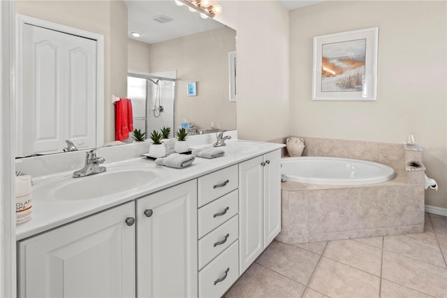 bathroom with plus walk in shower, vanity, and tile patterned flooring