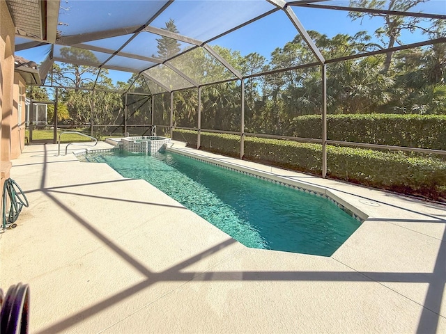 view of swimming pool with an in ground hot tub, a lanai, and a patio