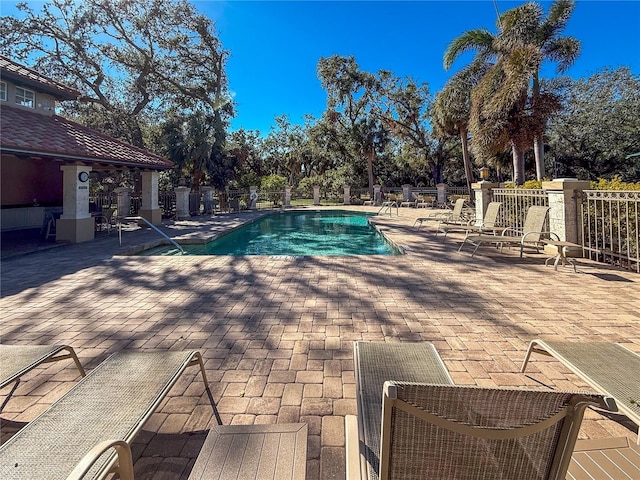 view of pool with central AC unit and a patio