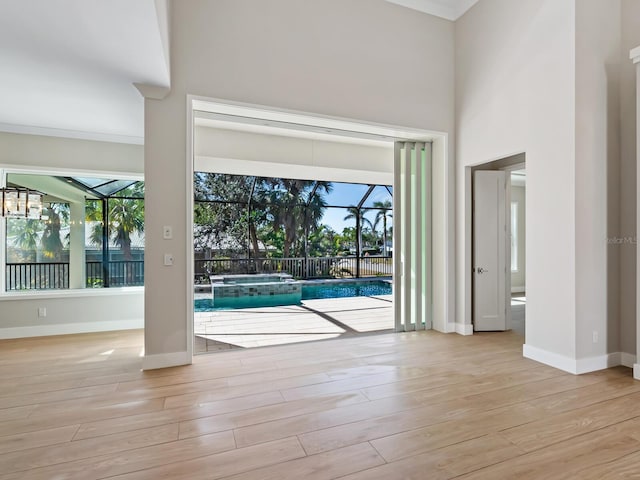 interior space with crown molding and light hardwood / wood-style flooring