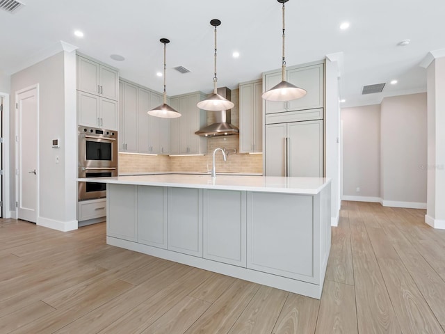 kitchen featuring gray cabinetry, a large island, paneled built in refrigerator, and stainless steel double oven