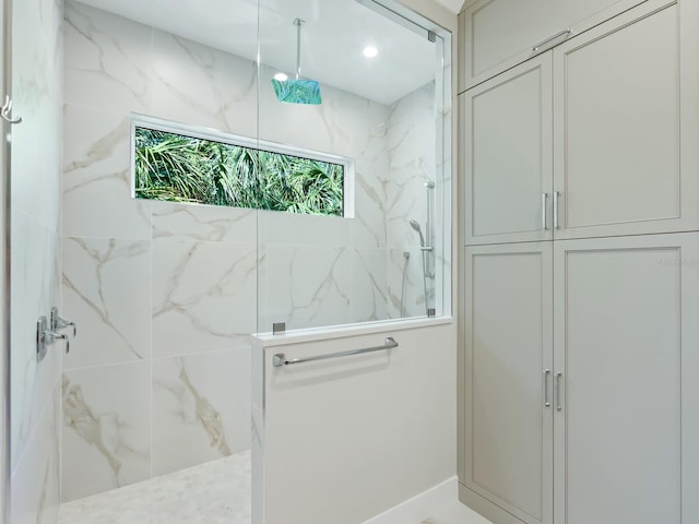 bathroom with a tile shower