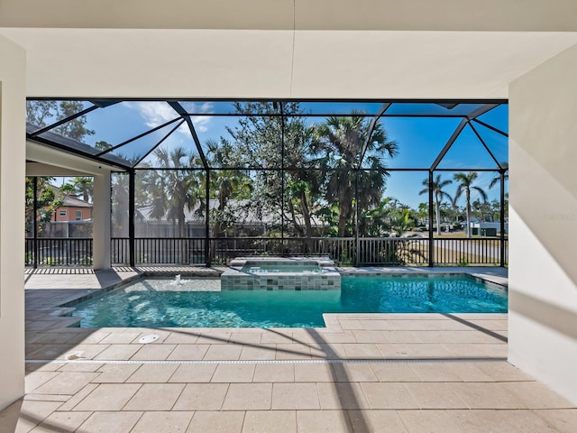 view of pool with an in ground hot tub, pool water feature, a patio area, and a lanai