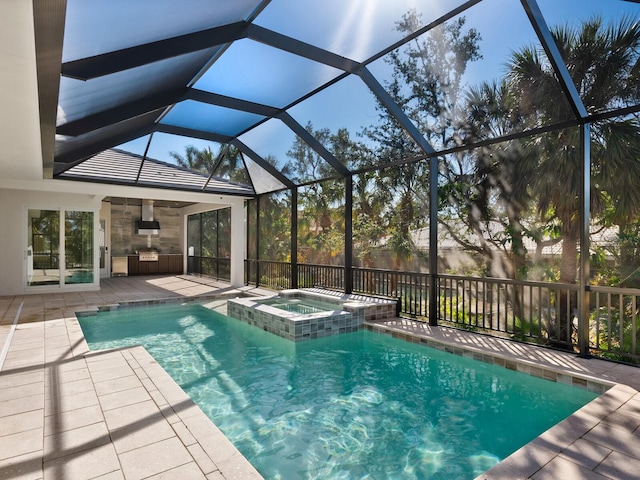 view of pool featuring an in ground hot tub, a patio, glass enclosure, and ceiling fan