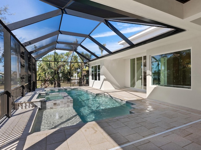 view of swimming pool featuring an in ground hot tub, glass enclosure, and a patio area