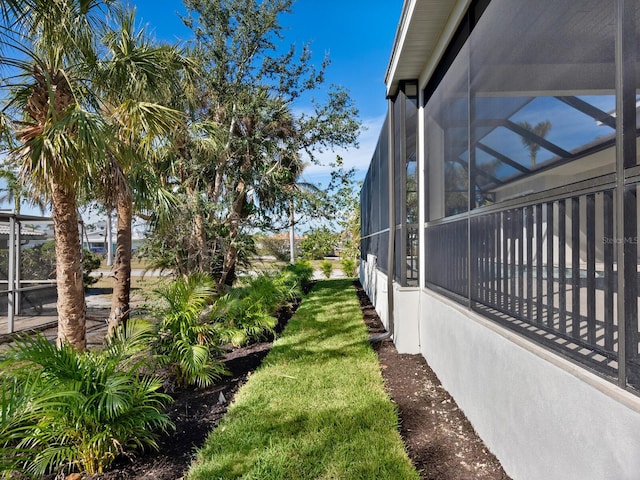 view of yard with glass enclosure