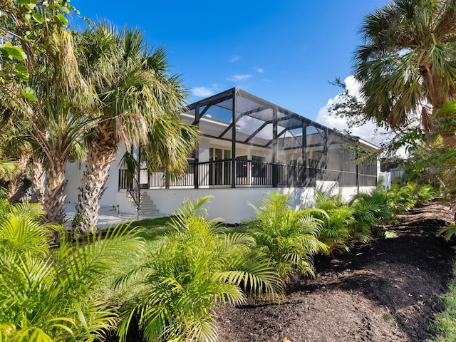 rear view of property featuring a lanai