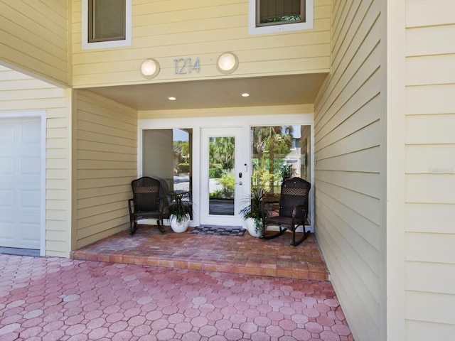 property entrance featuring a garage and visible vents