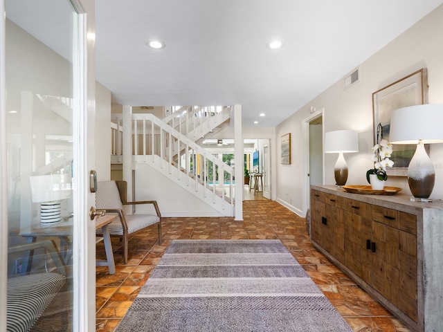 entrance foyer featuring recessed lighting, visible vents, baseboards, stairs, and stone finish flooring