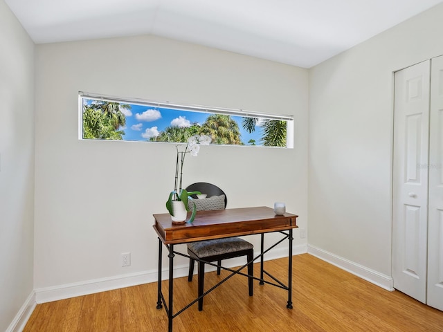 office space with baseboards and wood finished floors