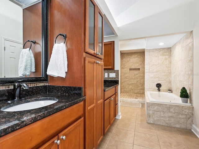 bathroom with tasteful backsplash, tiled shower, a garden tub, tile patterned flooring, and vanity