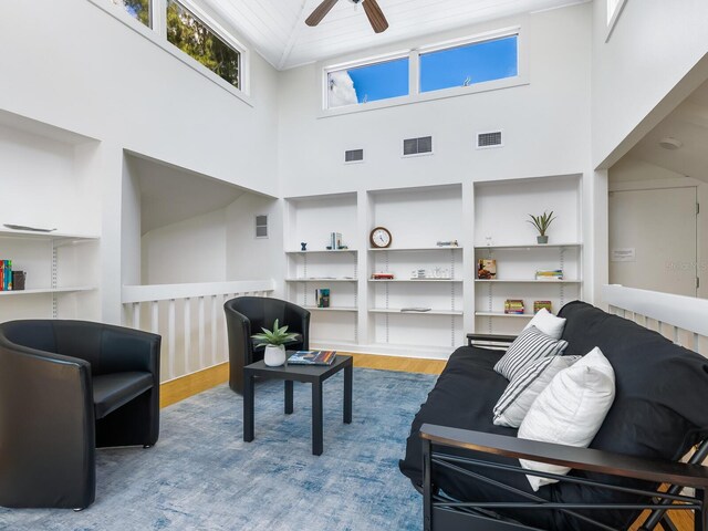 1214 Sea Plume Way, Sarasota, FL 34242 - living area with a towering ceiling, wood finished floors, a ceiling fan, and built in shelves