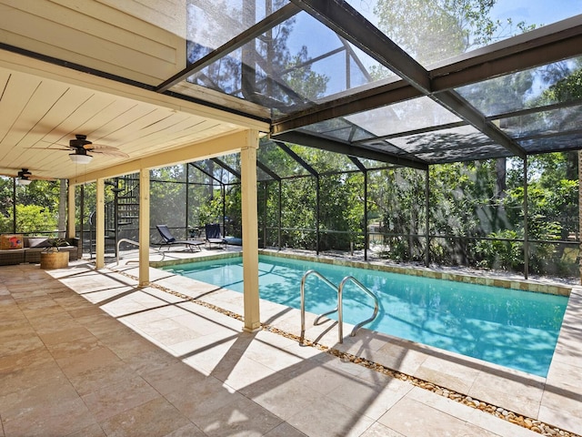 view of swimming pool featuring ceiling fan, a patio, and glass enclosure