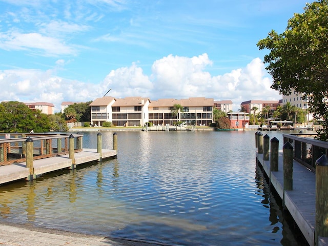 view of dock featuring a water view and a residential view