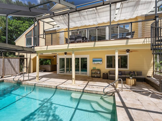 back of property featuring a patio, an outdoor living space, and a balcony