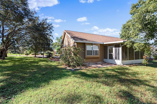 view of property exterior featuring a yard and a sunroom