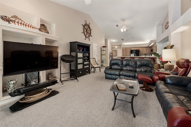 living room featuring high vaulted ceiling, light colored carpet, and ceiling fan