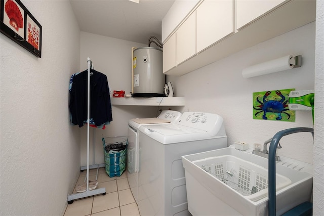 washroom with sink, cabinets, water heater, independent washer and dryer, and light tile patterned flooring