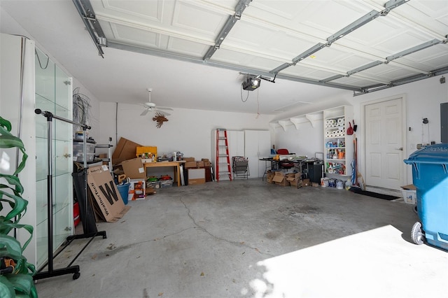 garage featuring electric panel, a garage door opener, and ceiling fan