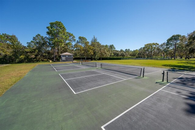 view of sport court featuring a yard