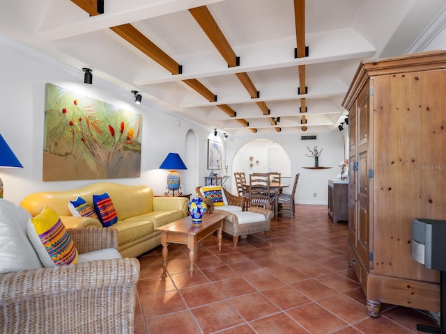 living room with beamed ceiling and tile patterned flooring