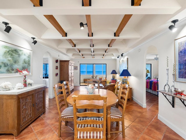 tiled dining space featuring coffered ceiling, beamed ceiling, and ceiling fan