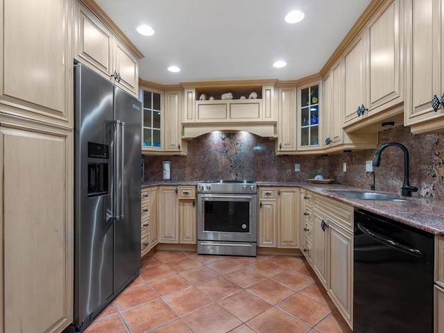 kitchen featuring sink, decorative backsplash, light tile patterned floors, and appliances with stainless steel finishes