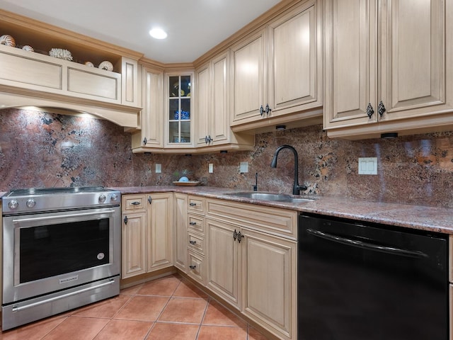 kitchen with sink, tasteful backsplash, light tile patterned floors, black dishwasher, and high end stove