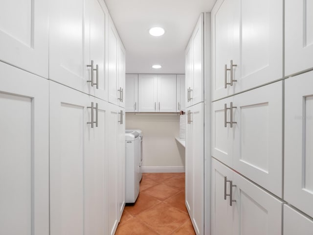 laundry area with light tile patterned floors, cabinets, and independent washer and dryer