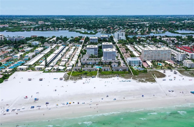 drone / aerial view featuring a beach view and a water view