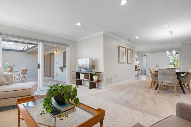 living room with ornamental molding, light carpet, and a chandelier