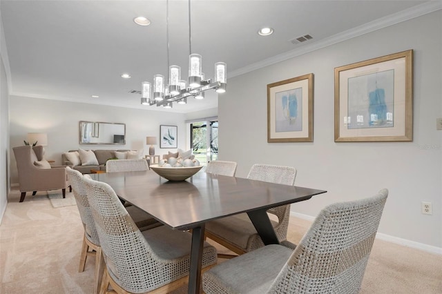 dining area featuring a chandelier, crown molding, and light colored carpet