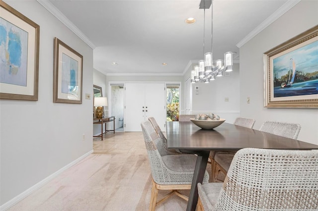 dining area with light carpet, an inviting chandelier, and crown molding