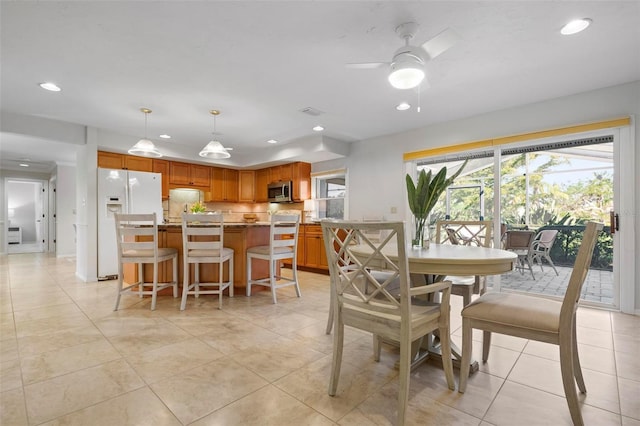 dining space featuring light tile patterned floors and ceiling fan