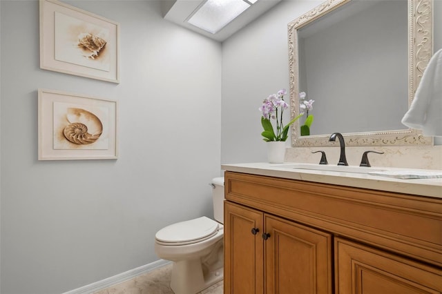 bathroom with tile patterned floors, vanity, and toilet