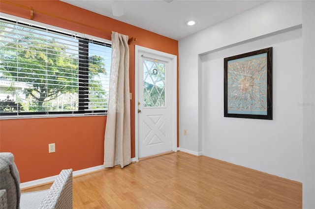 foyer entrance with a wealth of natural light and light hardwood / wood-style floors