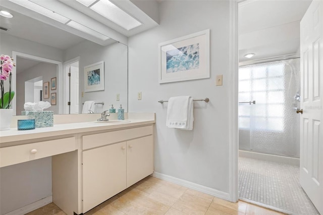 bathroom featuring tile patterned floors, vanity, and a shower with door